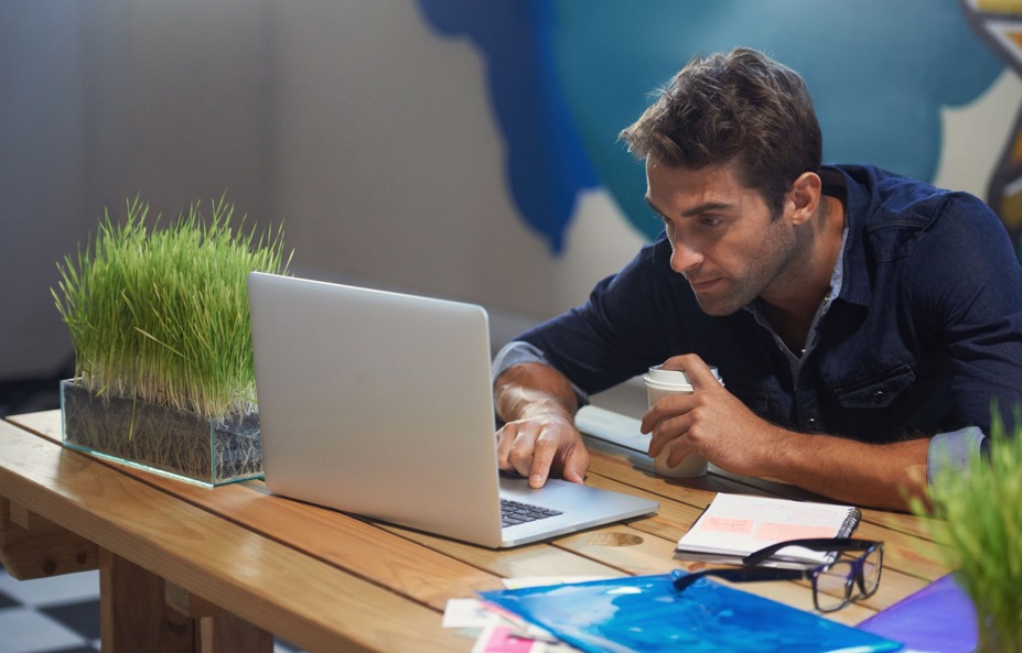 man-working-at-desk-with-laptop-and-coffee.jpg